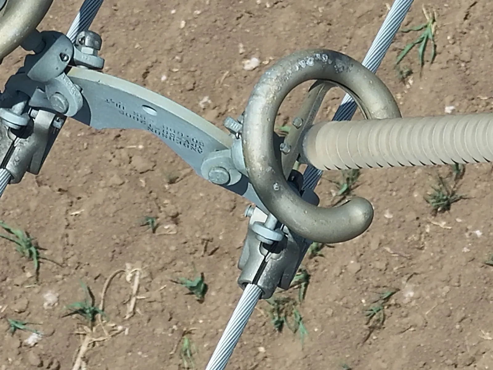 Close-up drone image of transmission insulator hardware, clevis and shackle